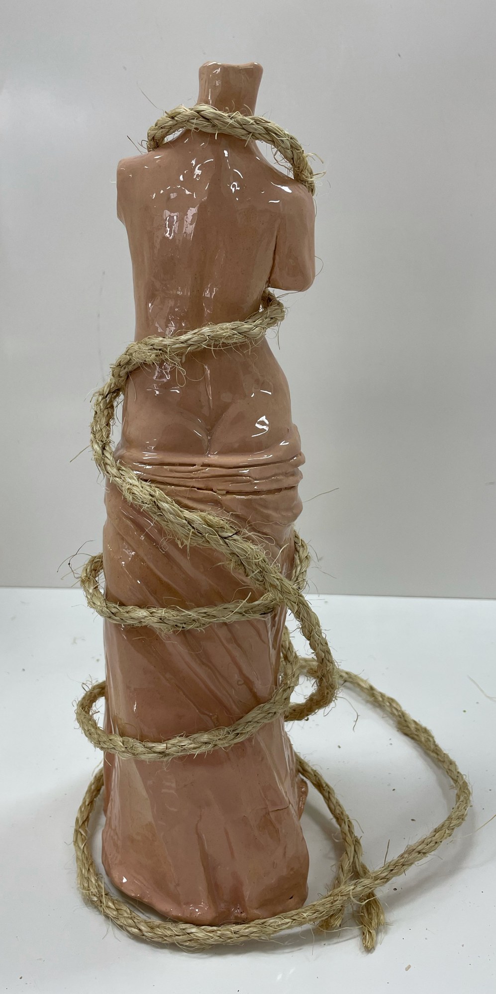 Asphyxiation, ceramic sculpture of a figure bound in rope, back view