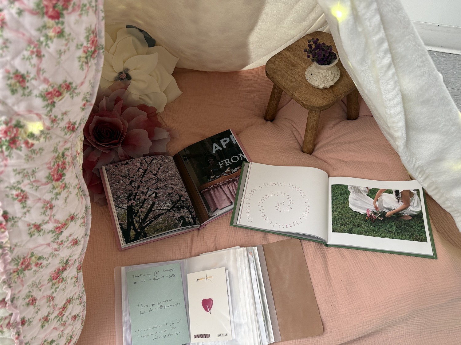 Inside the tent installation, The Drift Realm and Love Letter open beside the leather journal