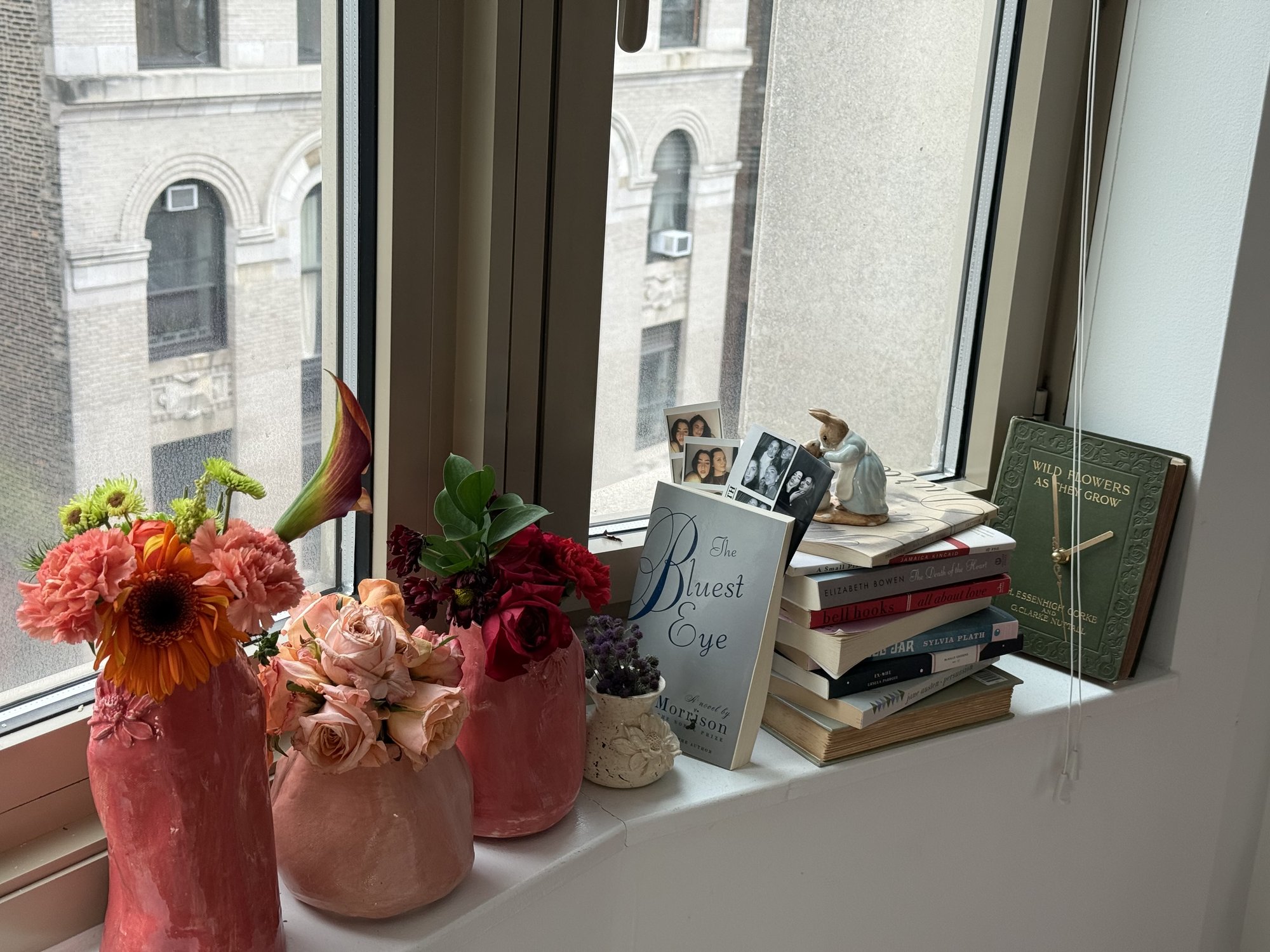Between Blooms ceramic vases holding fresh flowers on a windowsill