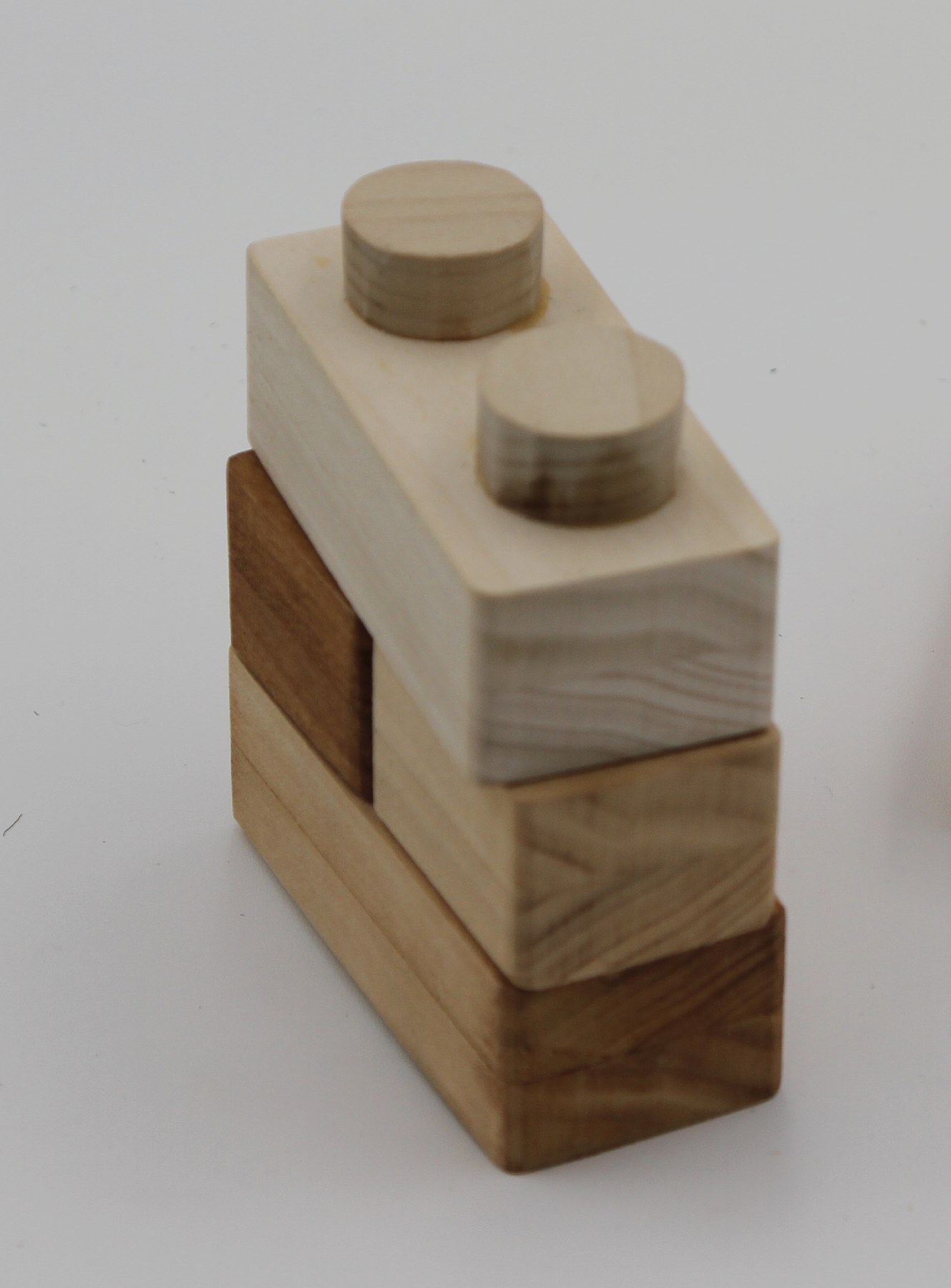 A stacked wooden block tower in two tones